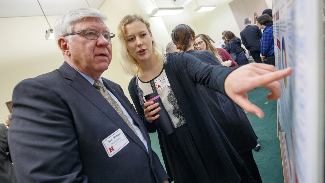 Regan Gilmore (right) explains her research on the statistical analysis of agriculture conservation practices to Sen. Robert Hilkemann during the 2018 Spring Research Fair. On April 16, 47 Huskers will discuss their research projects with senators.