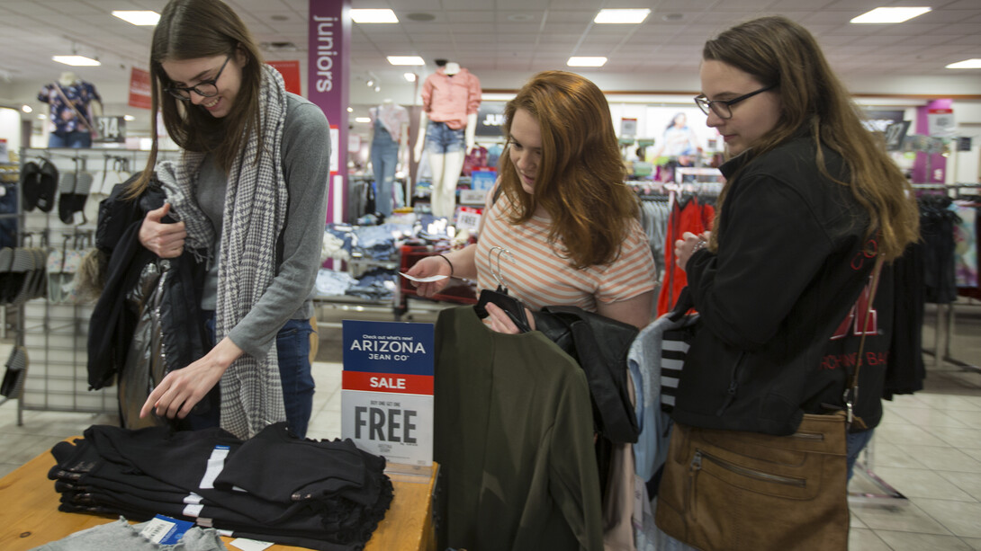 Nebraska juniors (from left) Elizabeth Spaulding, Christina Thibodeau and Marie Wagner consider a shirt purchase during the Suit Up event at the Gateway Mall J.C. Penney.