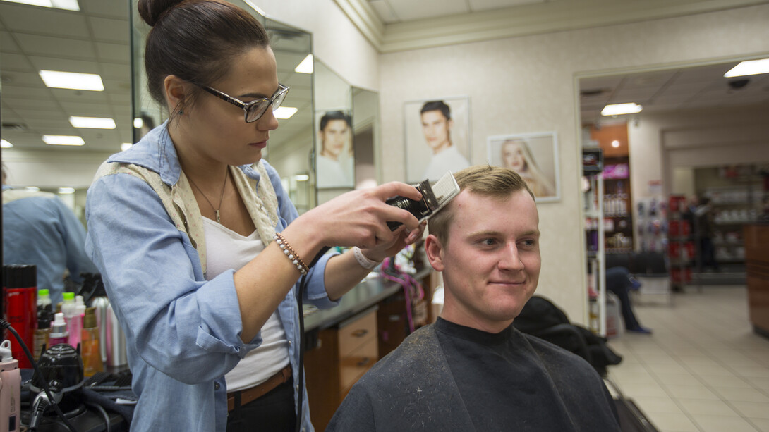 Kyle Murray, a junior professional golf management major from Beatrice, takes advantage of the $10 haircuts offered in the J.C. Penney salon during the April 15 Suit Up event.