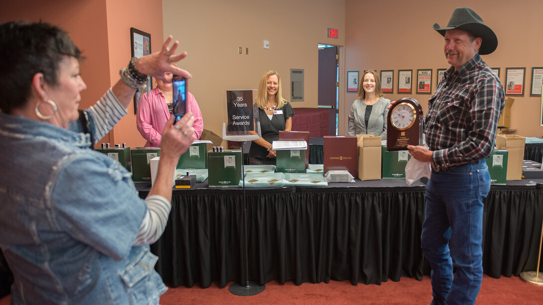 Michael Wilford (right) of the U.S. Meat Animal Research Center, poses for a photo with his 35-year Service Award prior to the start of the Celebration of Service. Award winners picked up their honors and attended a reception in the Lied Center for Performing Arts.