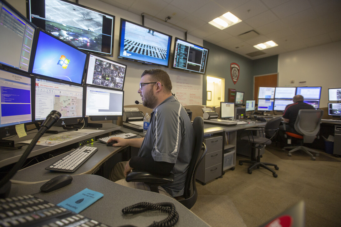 .Zach Fischer (left) and Jonathan Gentert work in the University Police dispatch center during the nigh shift on Oct. 4-5.