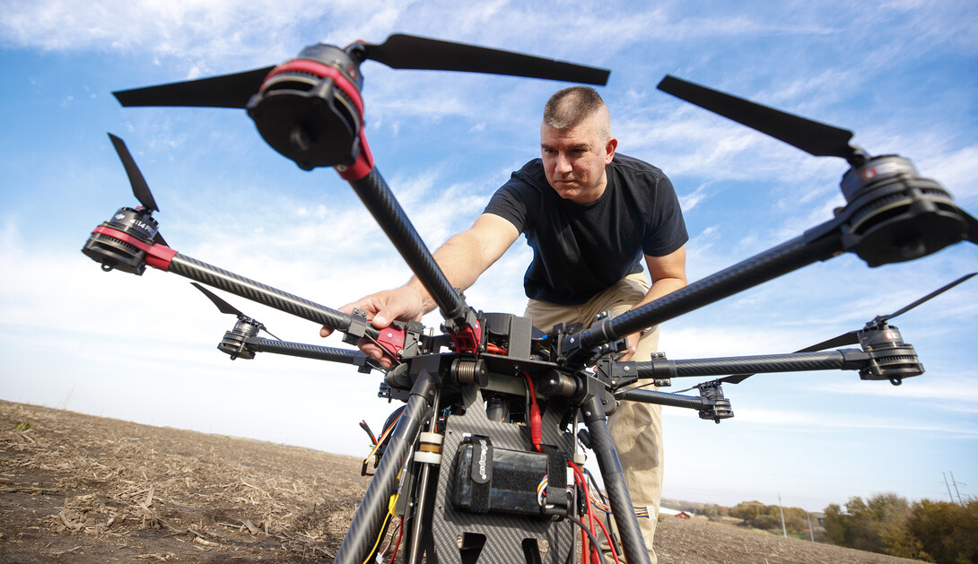 Adam Plowcha makes an adjustment to a drone prior to a test flight in rural Lancaster County. Plowcha served 20 years as a U.S. Navy pilot before seeking his doctorate at Nebraska.