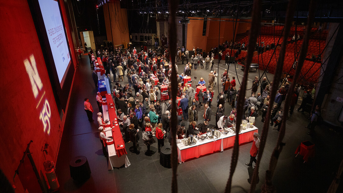 Students, faculty, staff, stakeholders and members of the public mingle on the Lied Center stage as part of a reception following the Jan. 15 State of the University address.