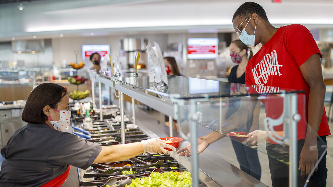 All masked up, students make lunch selections in the Cather Dining Center earlier this summer. In a July 23 email, Chancellor Ronnie Green outlined a number of safety protocols — including the use of facial coverings — that the university community will follow in the fall semester.