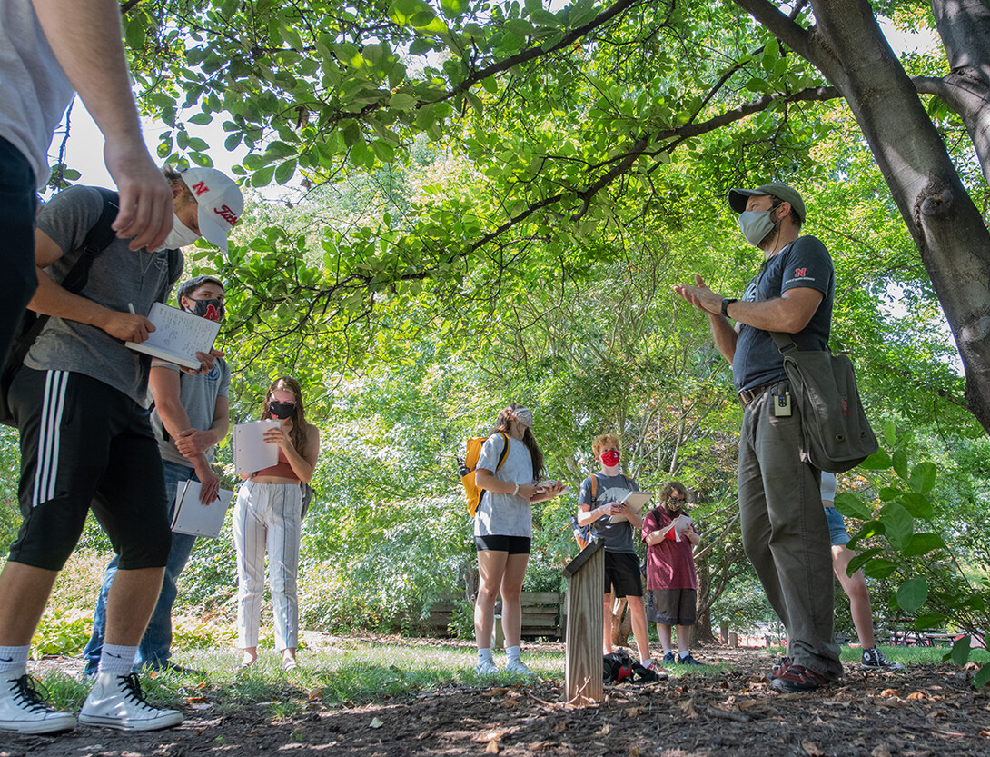 Students listen as Eric North, assistant professor of practice, outlines the features of a magnolia tree. This is just one example of how instructors are using the university's outdoor areas as teaching spaces.