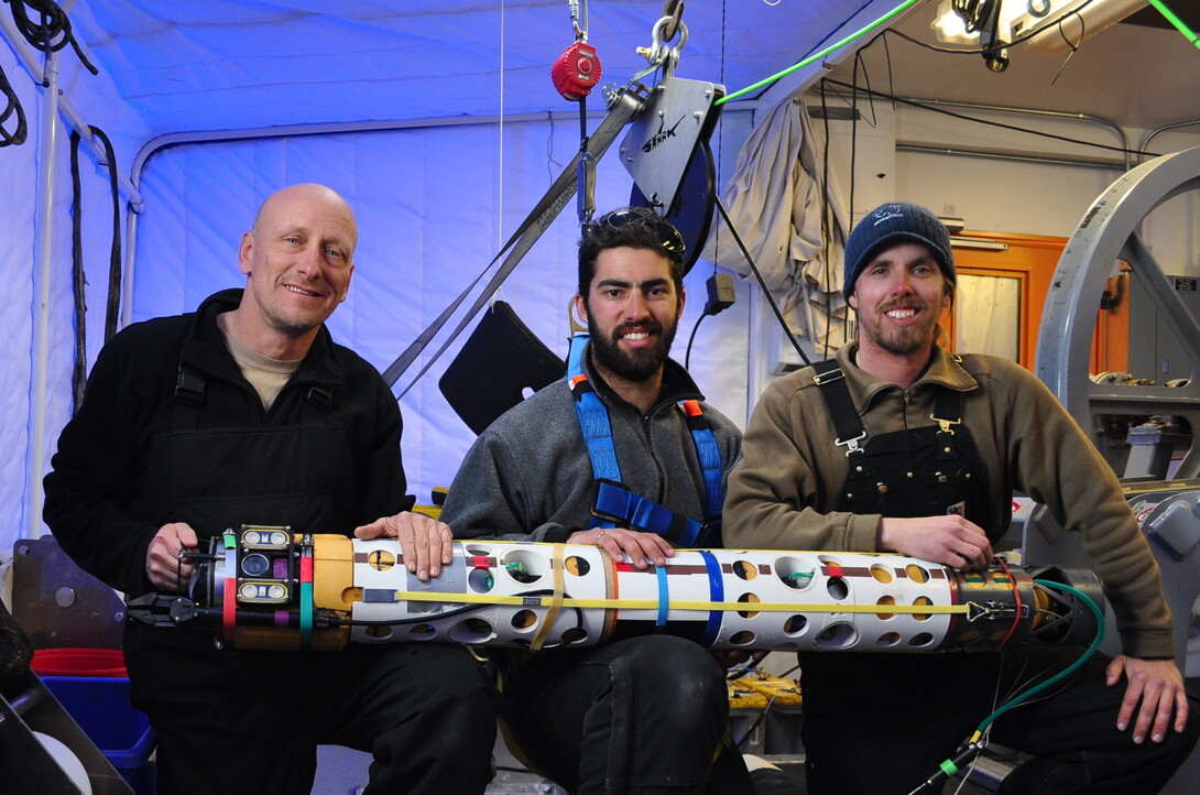 ANDRILL team members Bob Zook, Paul Mahecek and Dustin Carroll hold the underwater robot used to discover the sea anemone.