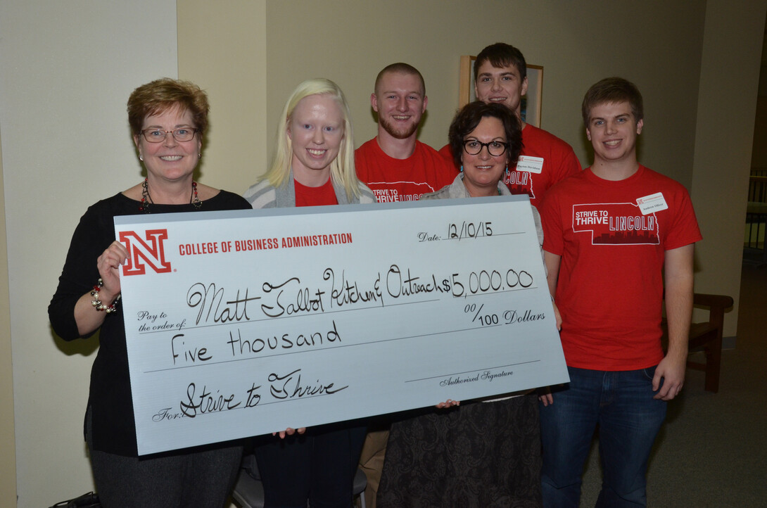 Matt Talbot Kitchen and Outreach representatives Sally Buchholz (left), director of development, and Susanne Blue, executive director, hold a $5,000 check from the Strive to Thrive Lincoln project. Also pictured are (from left) UNL students Liz Thompson, Matt Peck, Payton Davidson and Andrew Oliver, who participated in the class that made the grant decisions.