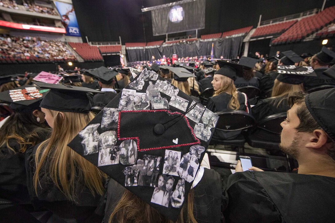 Kenzie Kucera, who earned a bachelor of science in education and human sciences, decorated her mortarboard with photos of friends and family.