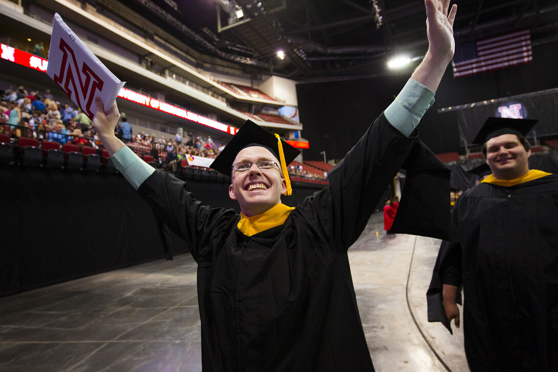 A student celebrates during the graduate and professional degrees ceremony on May 6.