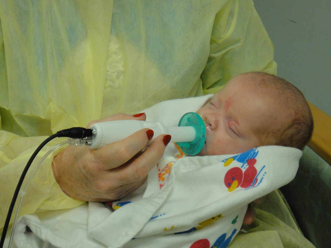 An infant uses the NTrainer System, a therapy device developed by UNL's Steven Barlow to stimulate early development of essential feeding skills in preterm infants.