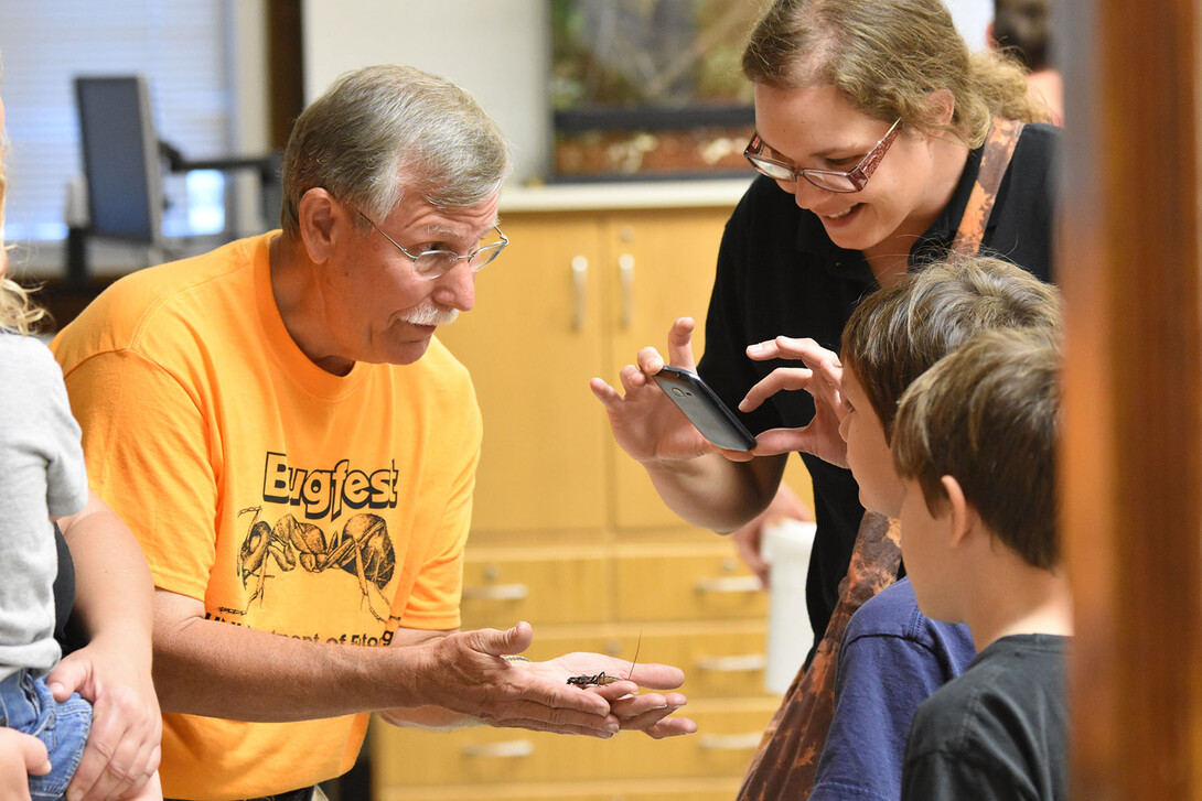 Entomology Professor Fred Baxendale introduces Vinnie the vinegaroon to a BugFest guest in 2015.