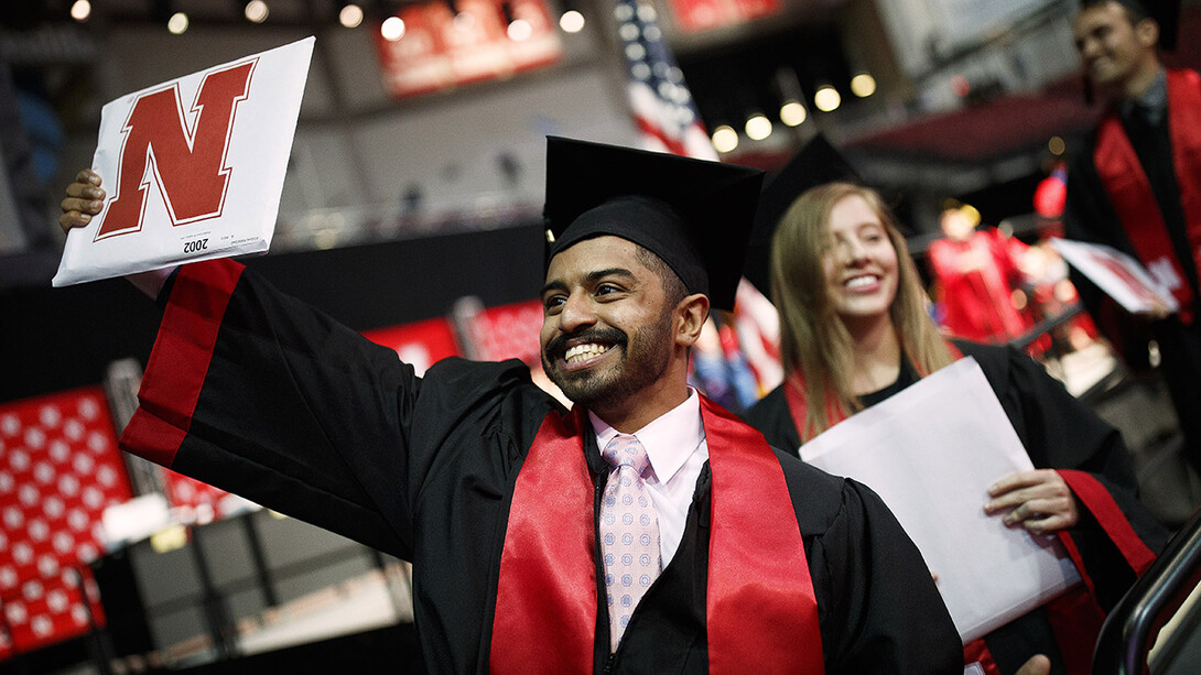 Khaled Saad Al Subaie waves to family and friends as he walks off stage after receiving his Bachelor of Journalism during the morning undergraduate commencement ceremony May 4 at Pinnacle Bank Arena.