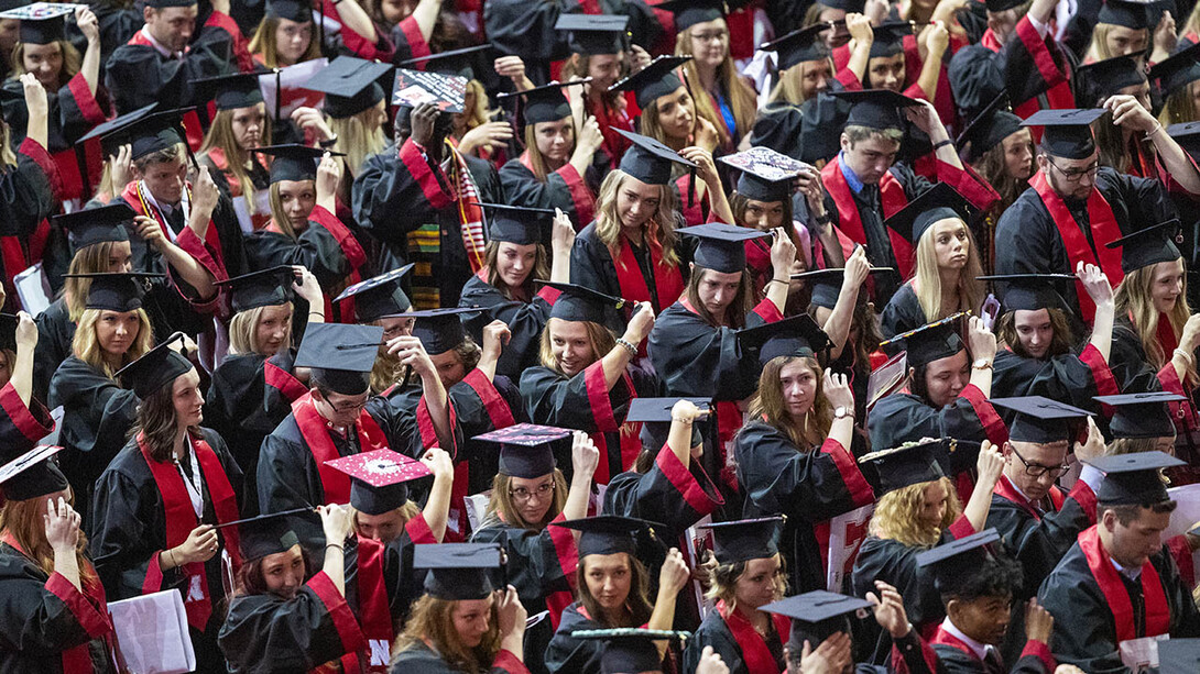 Huskers move their tassels from right to left to signify they are now graduates of the University of Nebraska-Lincoln at the end of the afternoon undergraduate commencement ceremony May 4 at Pinnacle Bank Arena.