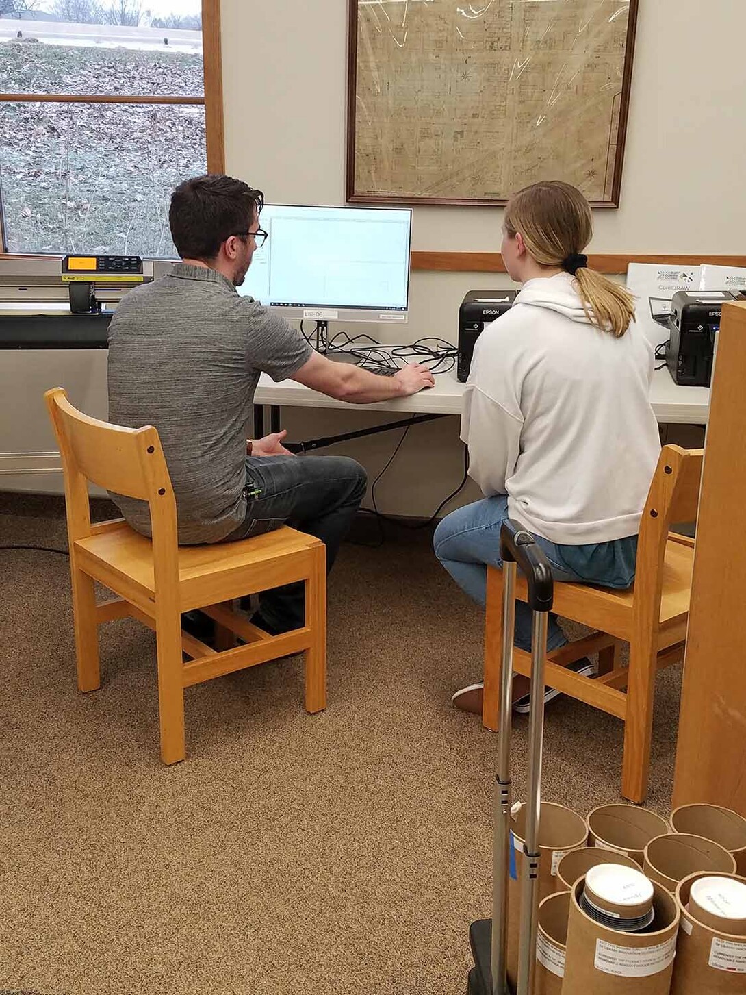 Max Wheeler, instructional designer with Nebraska Innovation Studio, shows a patron how to use a vinyl cutter at the Wayne Public Library in 2019.