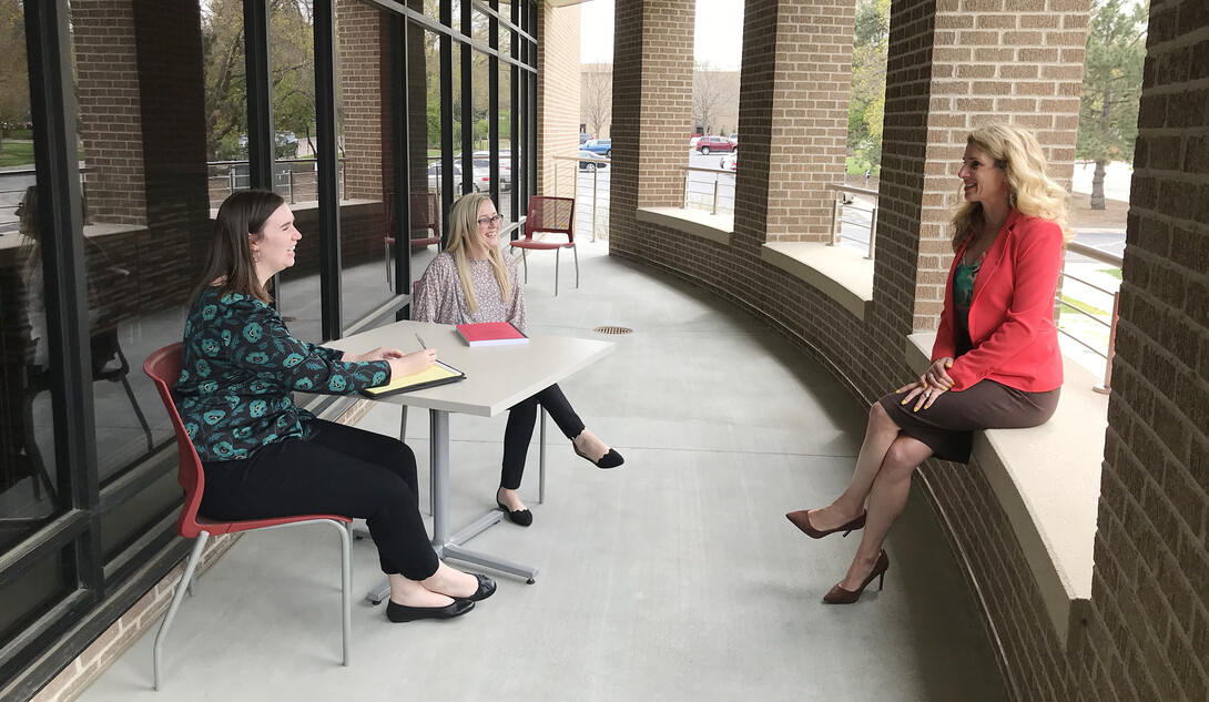 Claudia Brock (right), Rachel Lowe and Michelle Paxton talk outside the Schmid Clinic Building, where the Children's Justice Clinic is located.