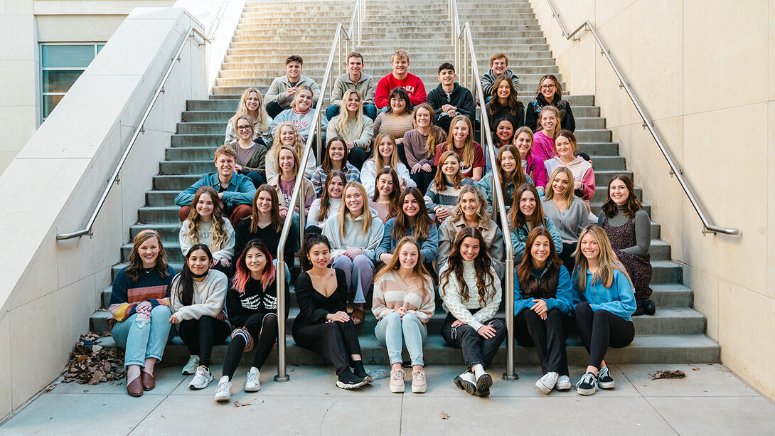 Student strengths coaches sit on a staircase