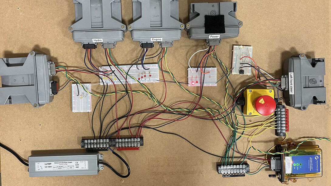 Overhead view of testbed setup with about a dozen electronic components connected with cables
