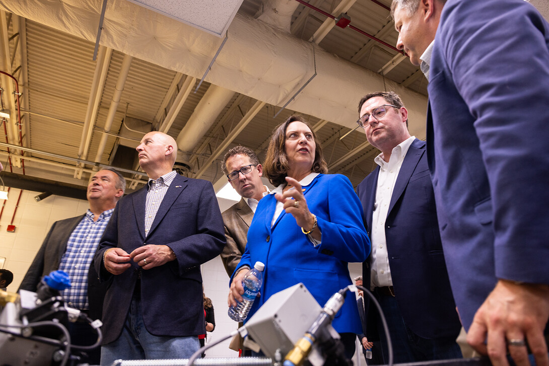 Members of the Nebraska delegation look on as Sen. Deb Fischer (center) talks with a university researcher during an East Campus visit on June 19.