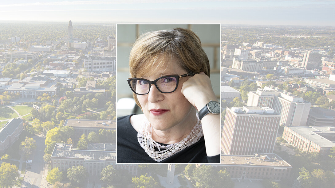 Color photo of Amy Herman on color campus background