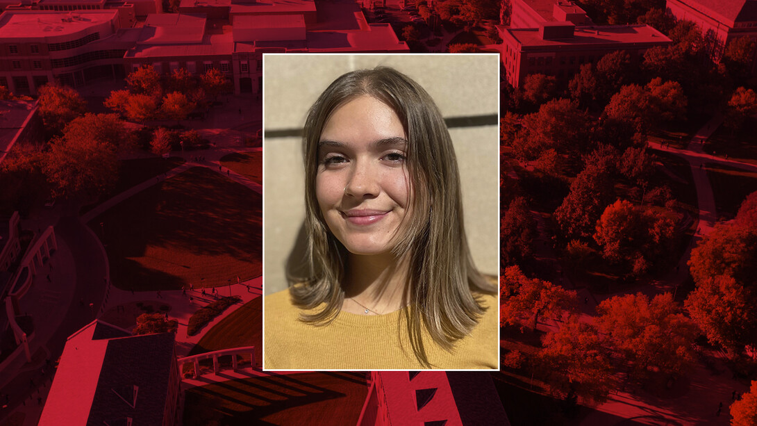 Color portrait of Jaela Hardin on red campus background