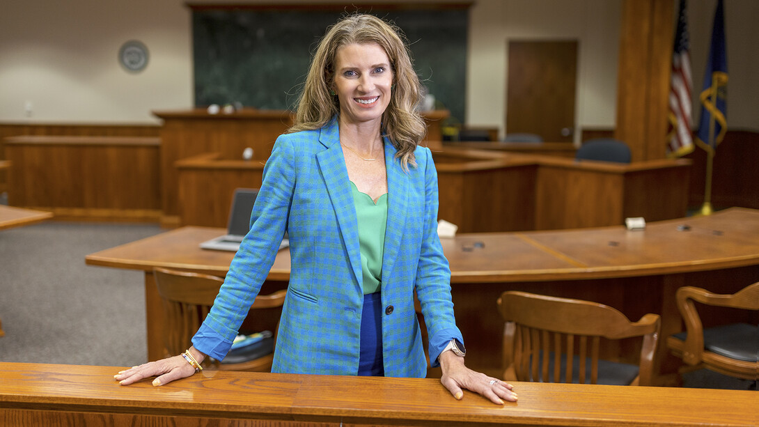 Professor Michelle Paxton stands in an empty courtroom.