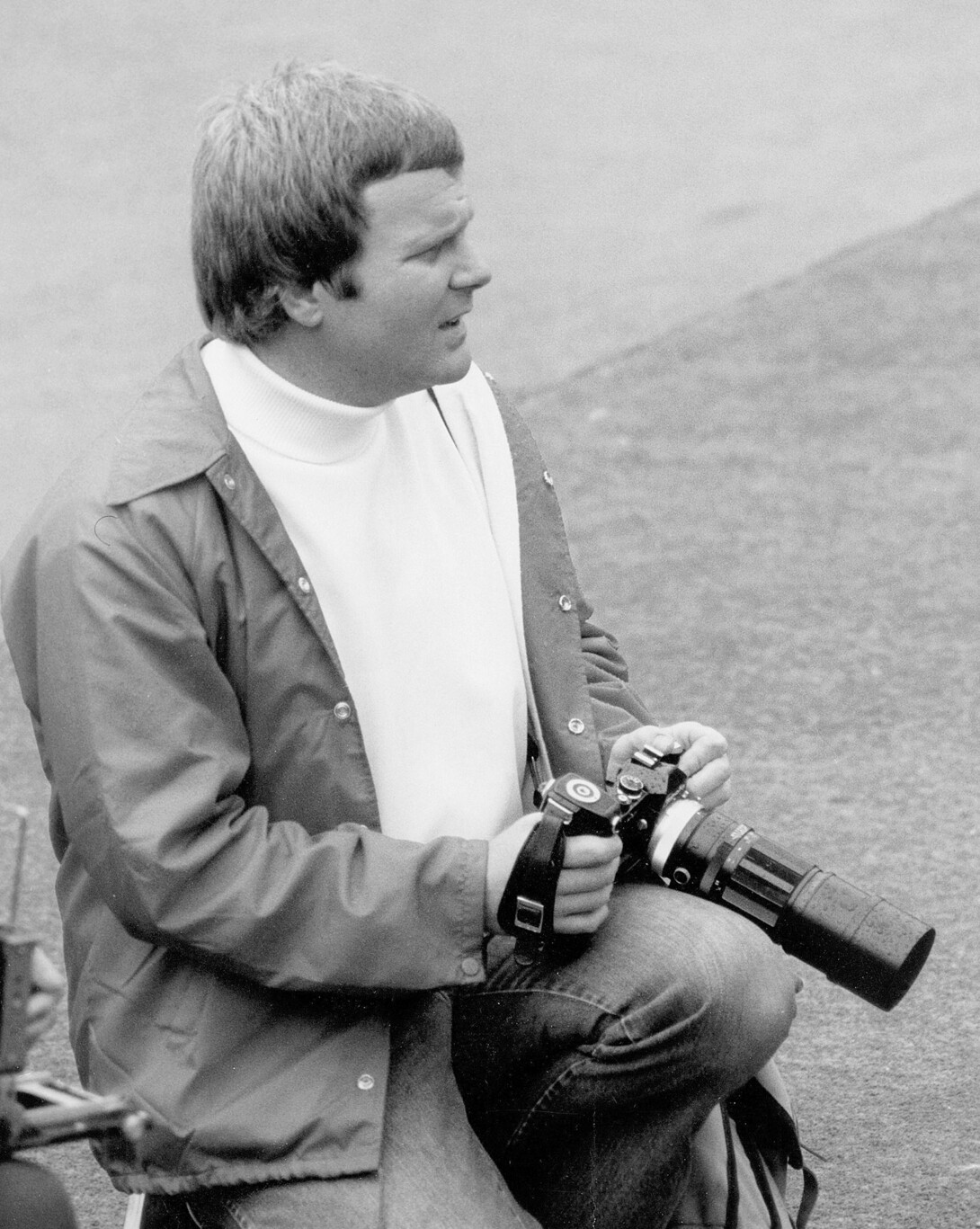 Black-and-white photo of Tom J. Slocum holding a camera