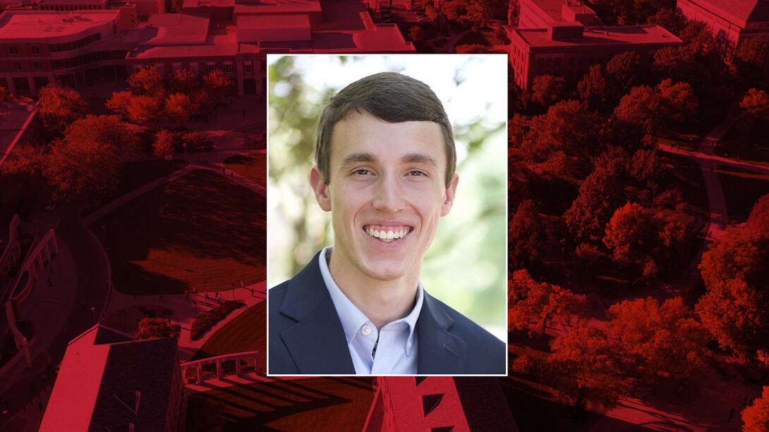 Color portrait of Hayden Ullmann on a red campus background