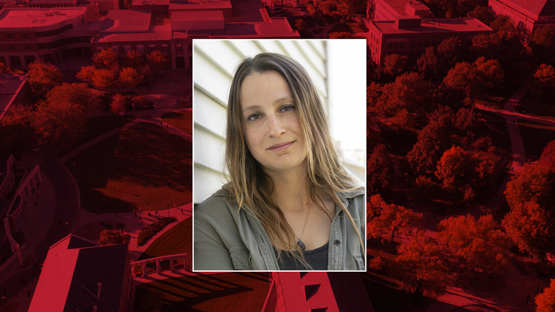 Color portrait of Laura Cobb on a red campus background