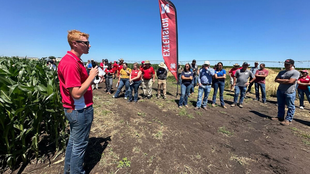 Adam Leise leads a Nebraska Extension session outdoors during a field day.