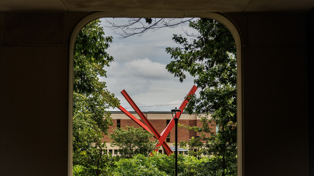The "Old Glory" sculpture is framed by an opening on the east side of Hamilton Hall.