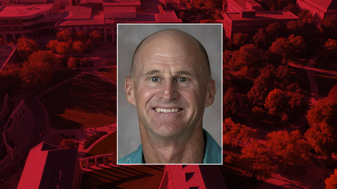 Color portrait of Jay Storz, Susan J. Rosowski Professor of biological sciences, on a red campus background.