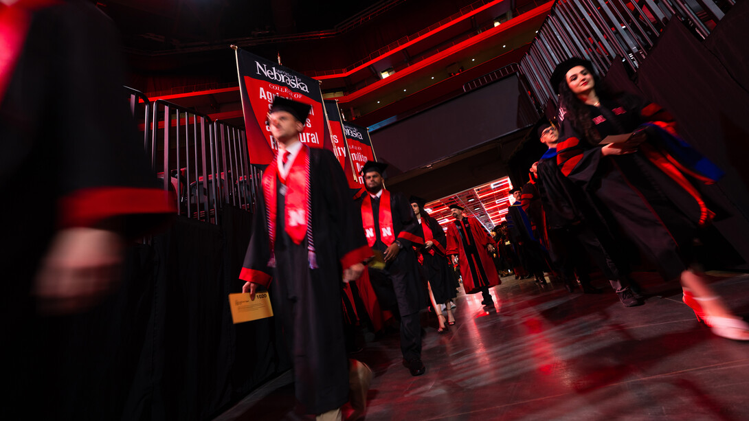 Graduates enter Pinnacle Bank Arena at the start of the summer commencement ceremony on Aug. 16.