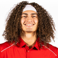 Color portrait of Josiah Allick, wearing a red polo and white headband.