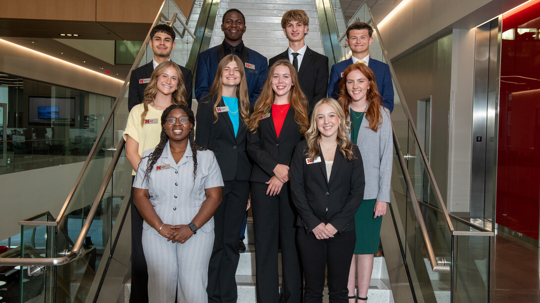 Four young men and six young women — all members of the 2025-26 cohort of Kiewit Scholars — pose for a photograph on a staircase in Kiewit Hall.