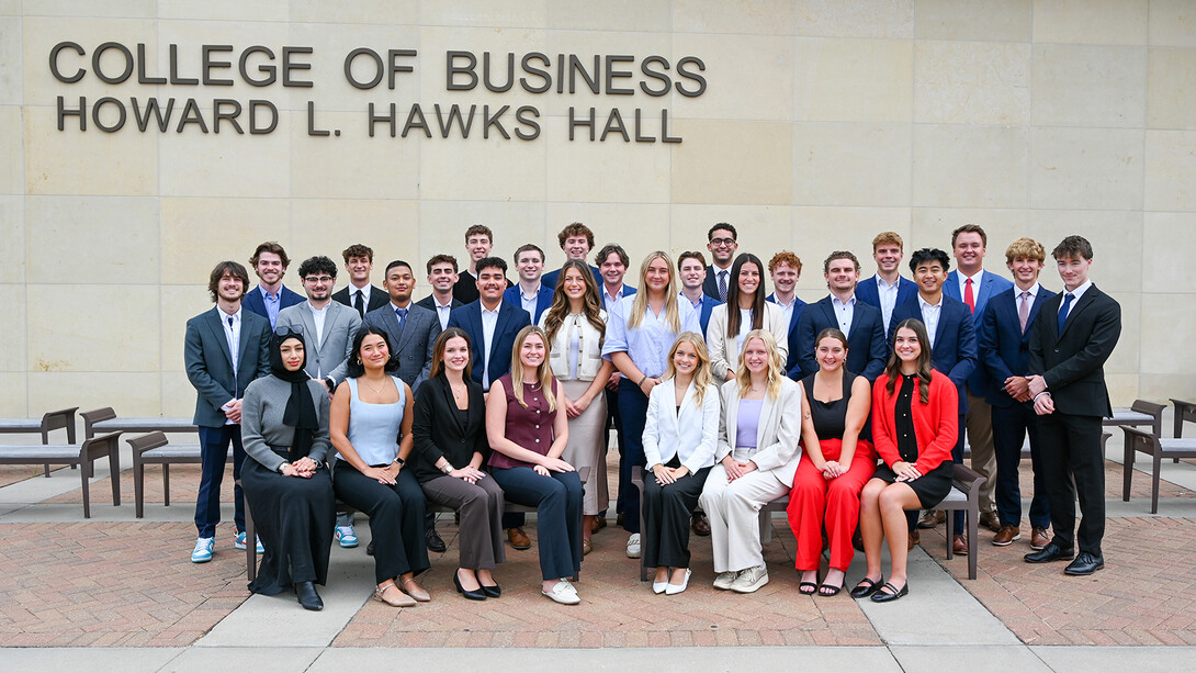 Thirty-one students — all members of the 10th cohort of the Clifton Builders Program at the University of Nebraska–Lincoln — pose for a photograph in formal attire on the west side of Howard L. Hawks Hall.