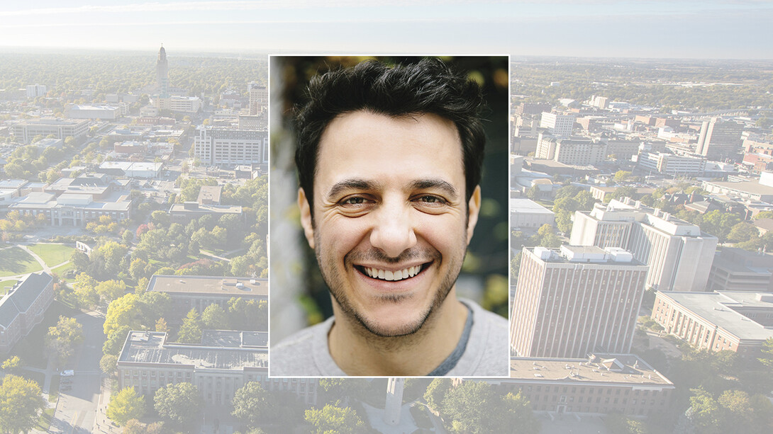 Color portrait of Tim Urban — author, blogger and illustrator — on a color campus background.