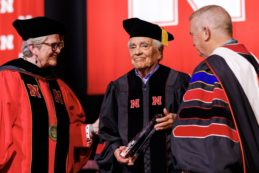 Richard L. Youngscap (center) is presented an award onstage by Interim Chancellor Katherine S. Ankerson and Regent Tim Clare.