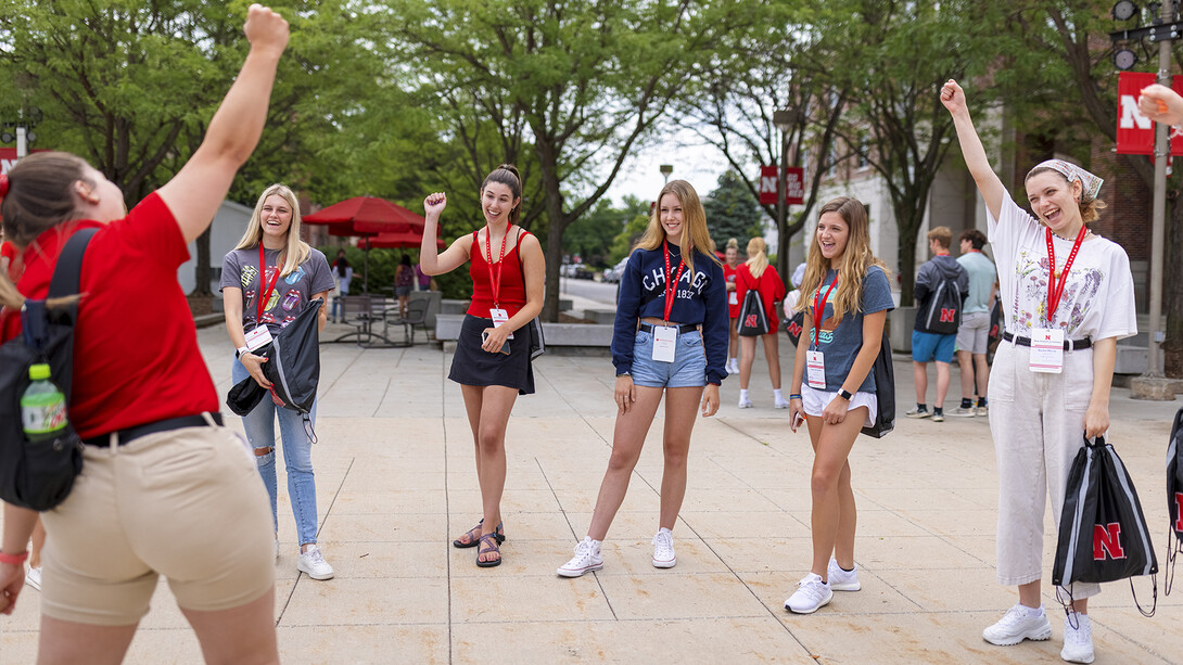 Luiza Benvenuti (left) fires up her student group prior to introductions during a New Student Enrollment session on June 24.