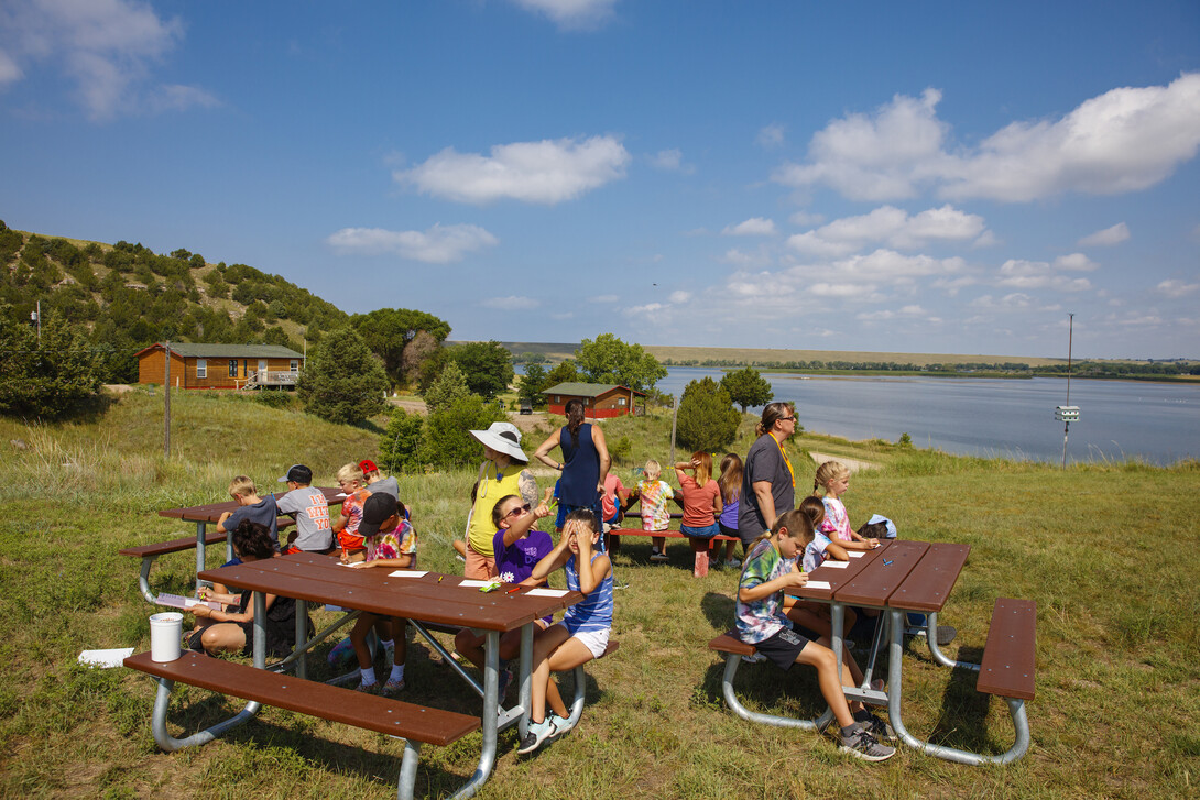 Campers complete art projects near Lake Olgallala at Cedar Point Biological Station.