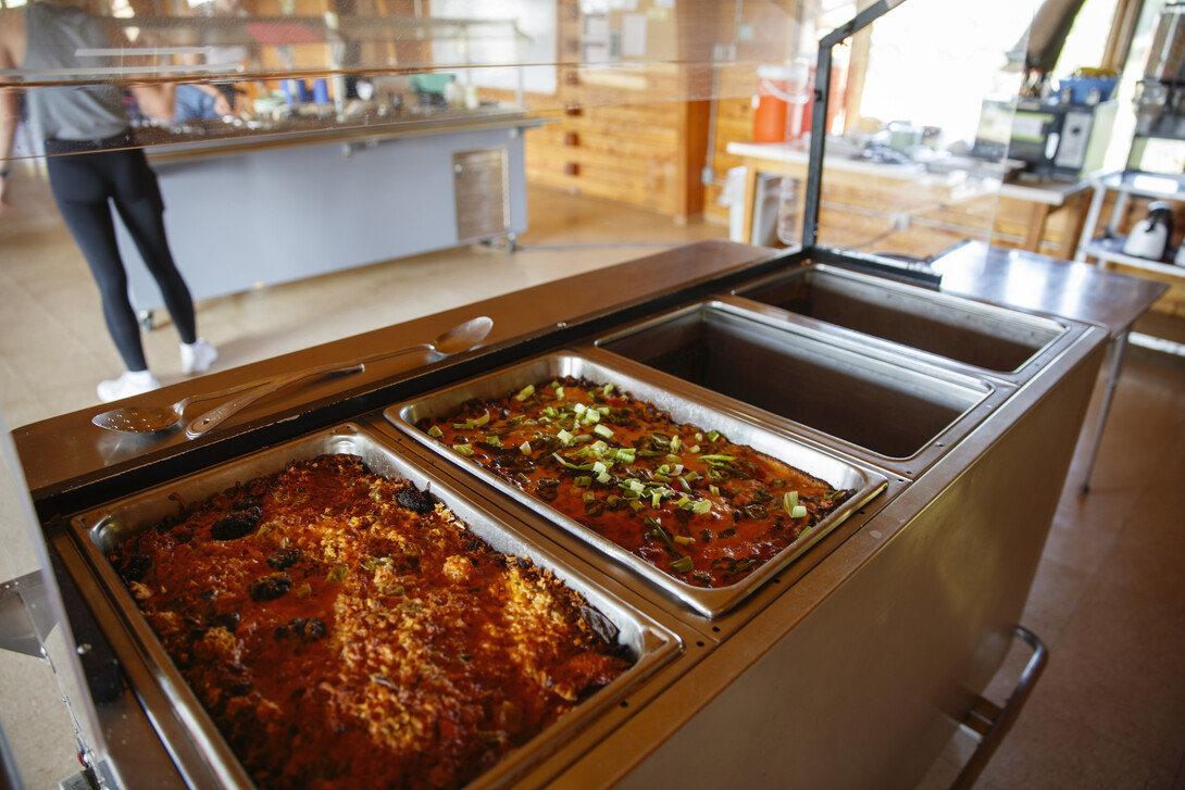 Casserole bakes (front) and a salad bar (back) are set up in advance before dinner.