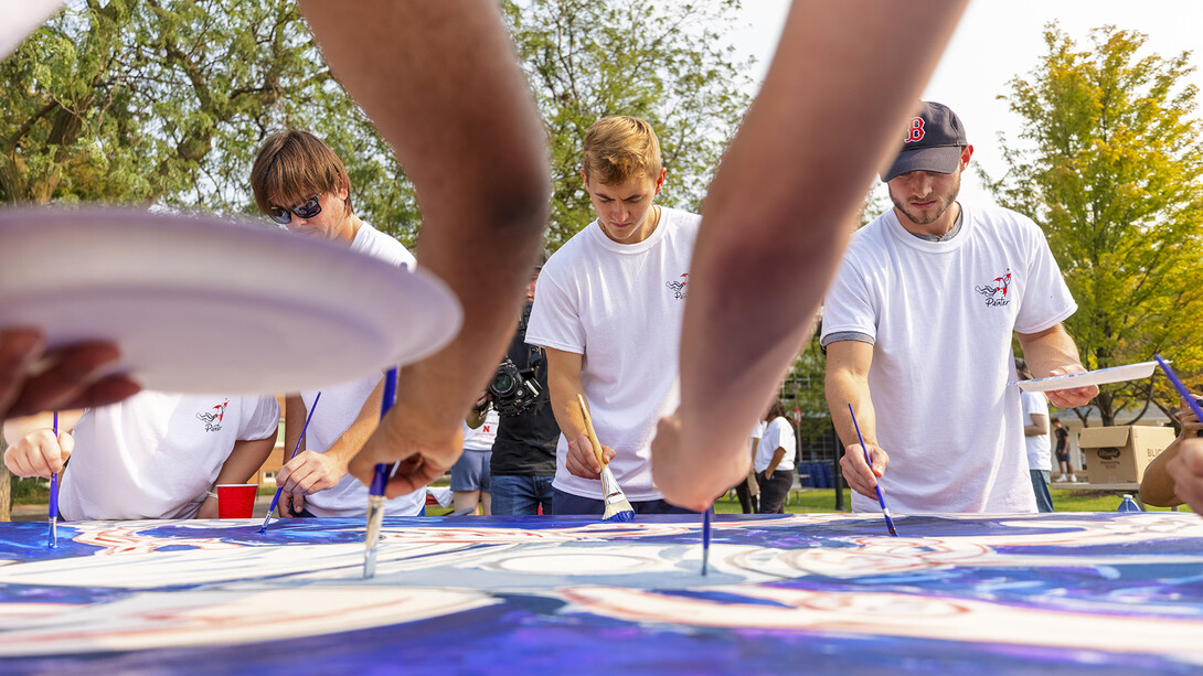 Students paint The Palette Project's first mural, a rocket, on campus on Sept.1.