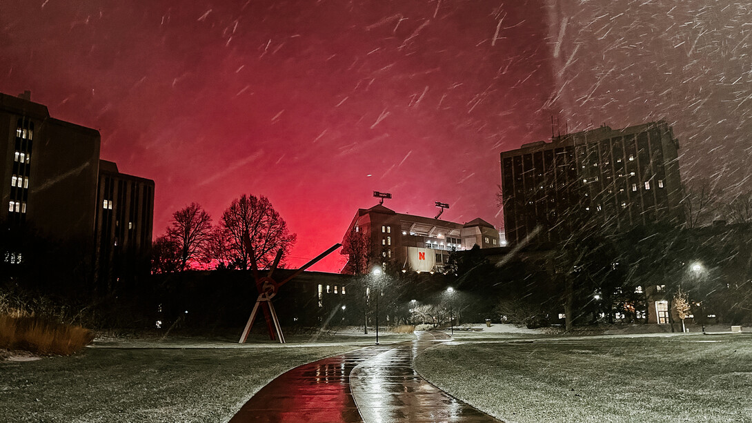 As snow flew on Dec. 10, the lights of Memorial Stadium lit up the evening sky, reflecting red against the low clouds.