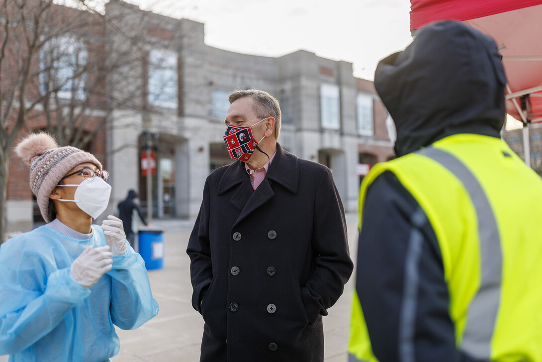 Chancellor Ronnie Green talks with COVID Testing Site Supervisor Myra Ferrara and William Barrera outside the Nebraska Union testing site.  January 19, 2022