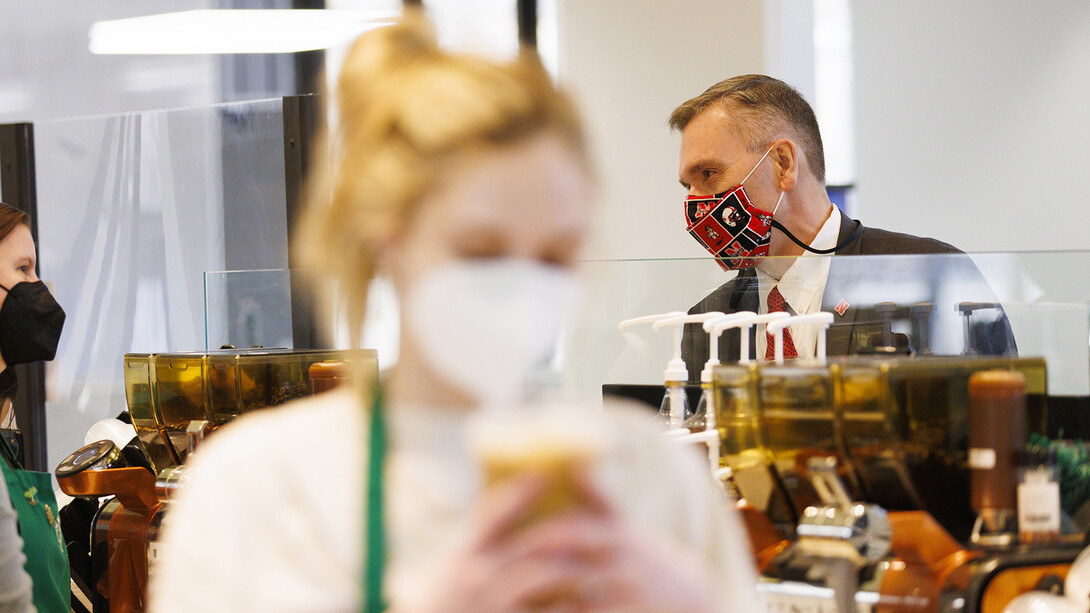 Chancellor Ronnie Green chats with a worker as he waits for his coffee at the Starbucks in the Nebraska East Union on Feb. 16.