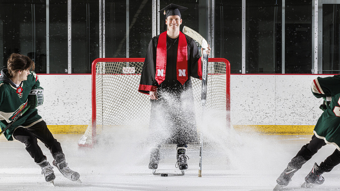 Alex Cathcart came to Nebraska to pursue a hockey career hockey, but he scored with a mathematics degree from the University of Nebraska–Lincoln. He is assisted in the photo by John Rupert, a sophomore from Minnesota.