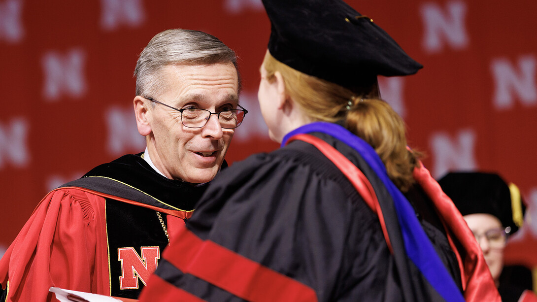 Chancellor Ronnie Green congratulates a graduate during the graduate commencement on Dec. 16. Green took time to talk with each student as they received their degrees during the university's doctoral/master's degree ceremony.