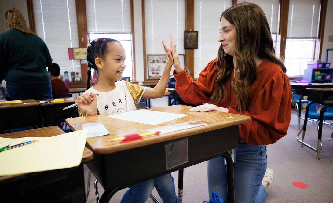 Morgan Twiss, a senior in the Teacher Scholars Academy, works with a second-grader at Elliott Elementary, where she is student-teaching.