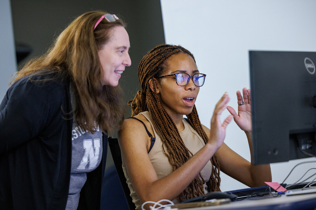 Laura Weakly (left), metadata encoding specialist, works with a student in the Digital Legal Research Lab. 