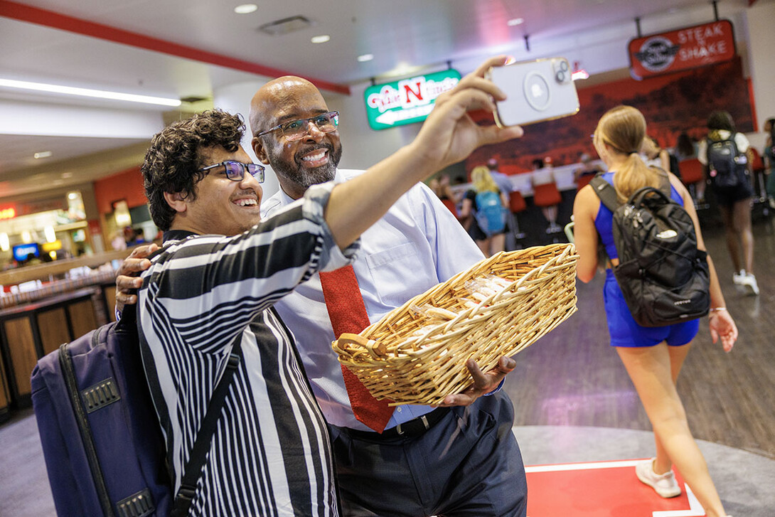 Chancellor Rodney Bennett poses with Rashedul Hasan during the chancellor’s cookie give-away Monday morning.