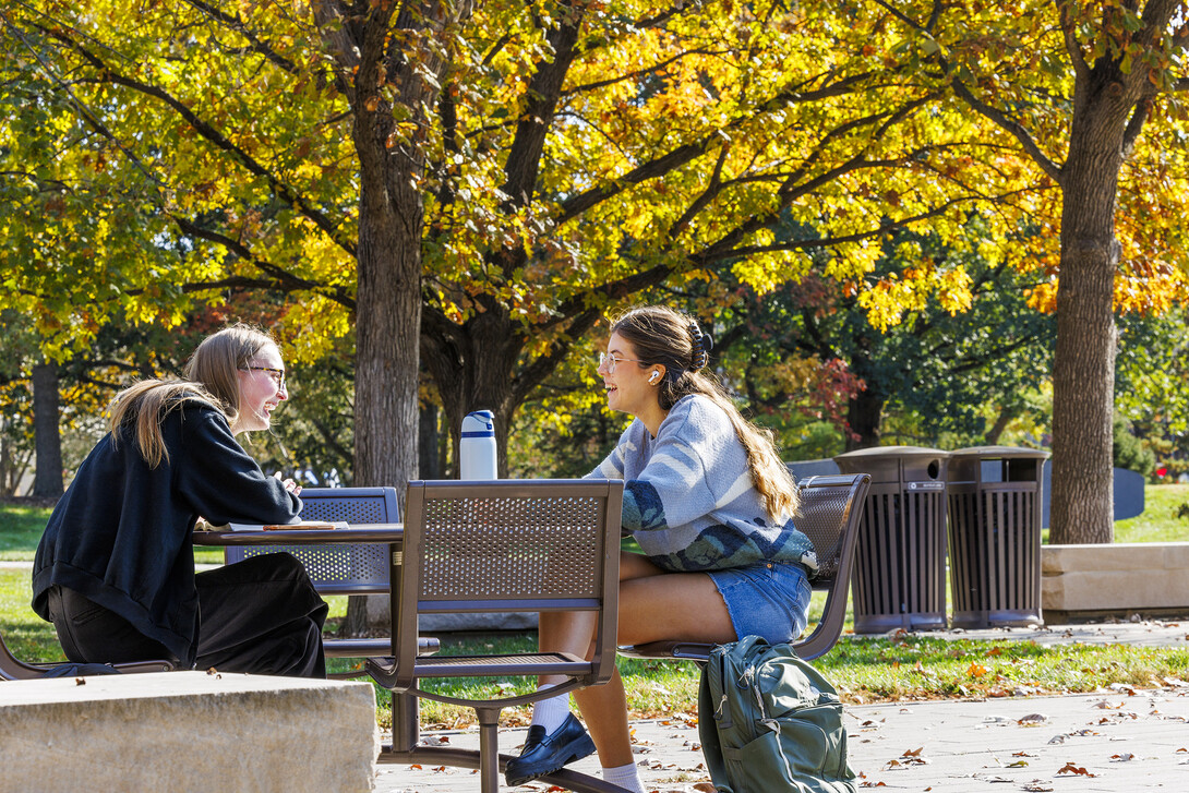 Josie Bartels, a junior from Lincoln, left, and Audrey Ellis, a sophomore from Fort Worth, Texas, laugh over the various methods of murder Bartels’ criminal justice book describes as they study outside of the Adele Coryell Hall Learning Commons.